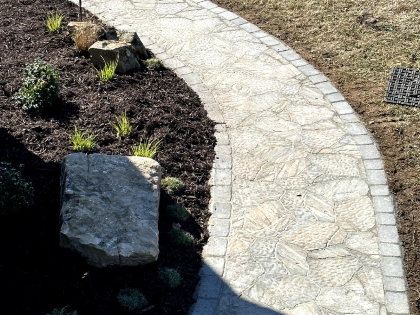 A stone path in the middle of a garden.