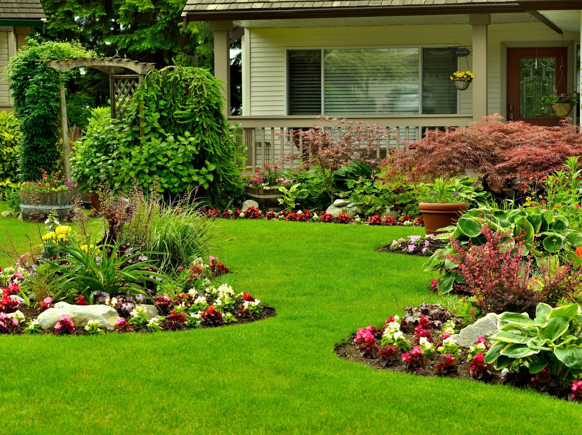 A garden with flowers and grass in the middle of it